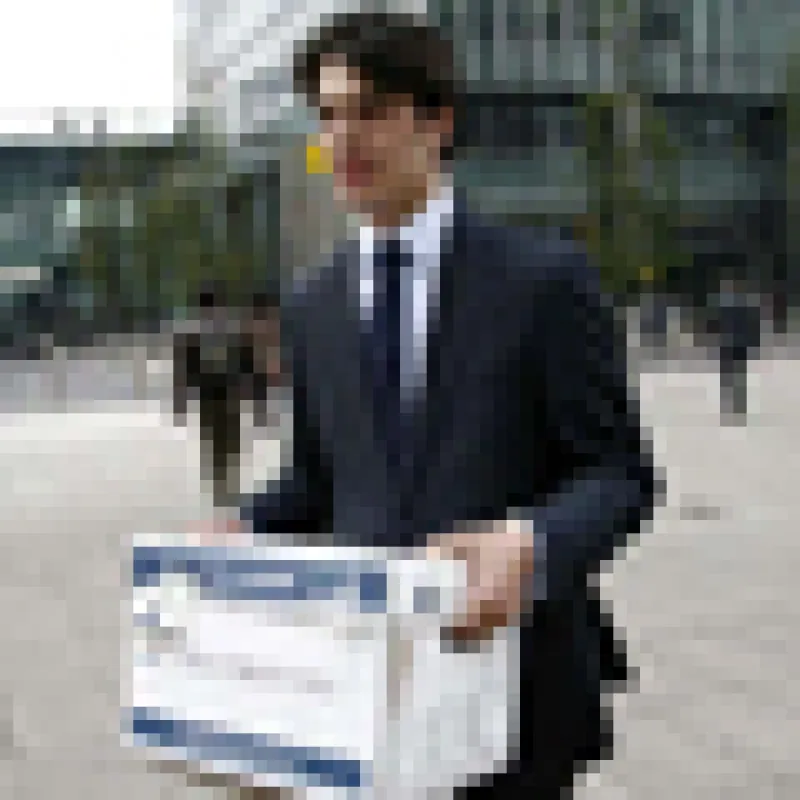 A Lehman Brothers employee carries a box away from the office of the U.S. investment bank in London