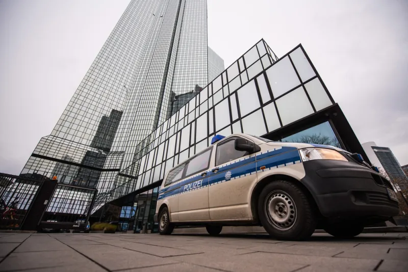 A police van sits outside the headquarters of Deutsche Bank on Nov. 29, 2018. (Andreas Arnold/Bloomberg)