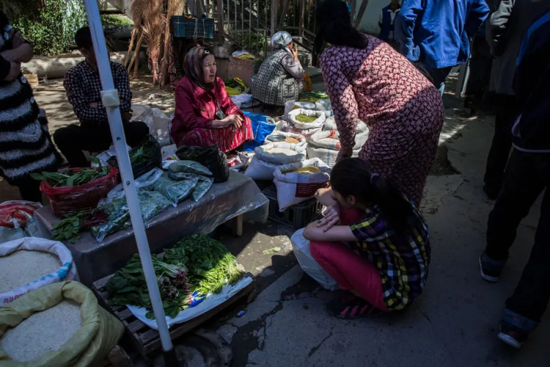 Shoppers browse a vegetable stall at a market in Dushanbe, Tajikistan. (Taylor Weidman/Bloomberg)