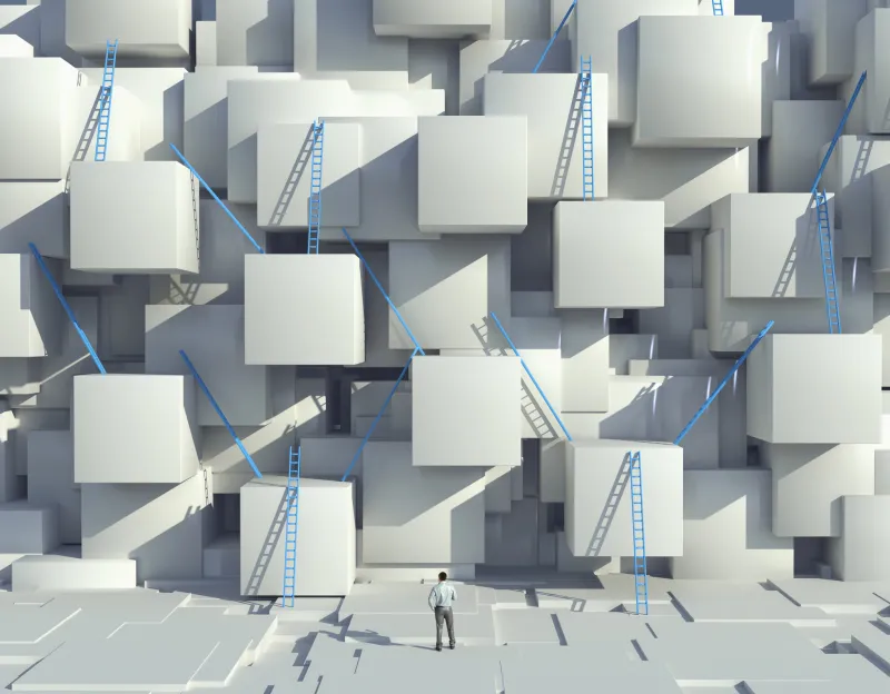 Caucasian man looking at blue ladders on cube wall